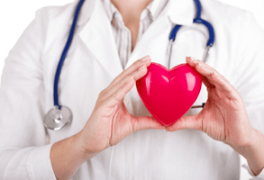  A doctor holding a plastic heart which they’re using to highlight their focus on utilising health assessment software to better prioritise preventative health care.